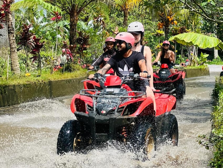 Tandem ATV riders on a tropical trail