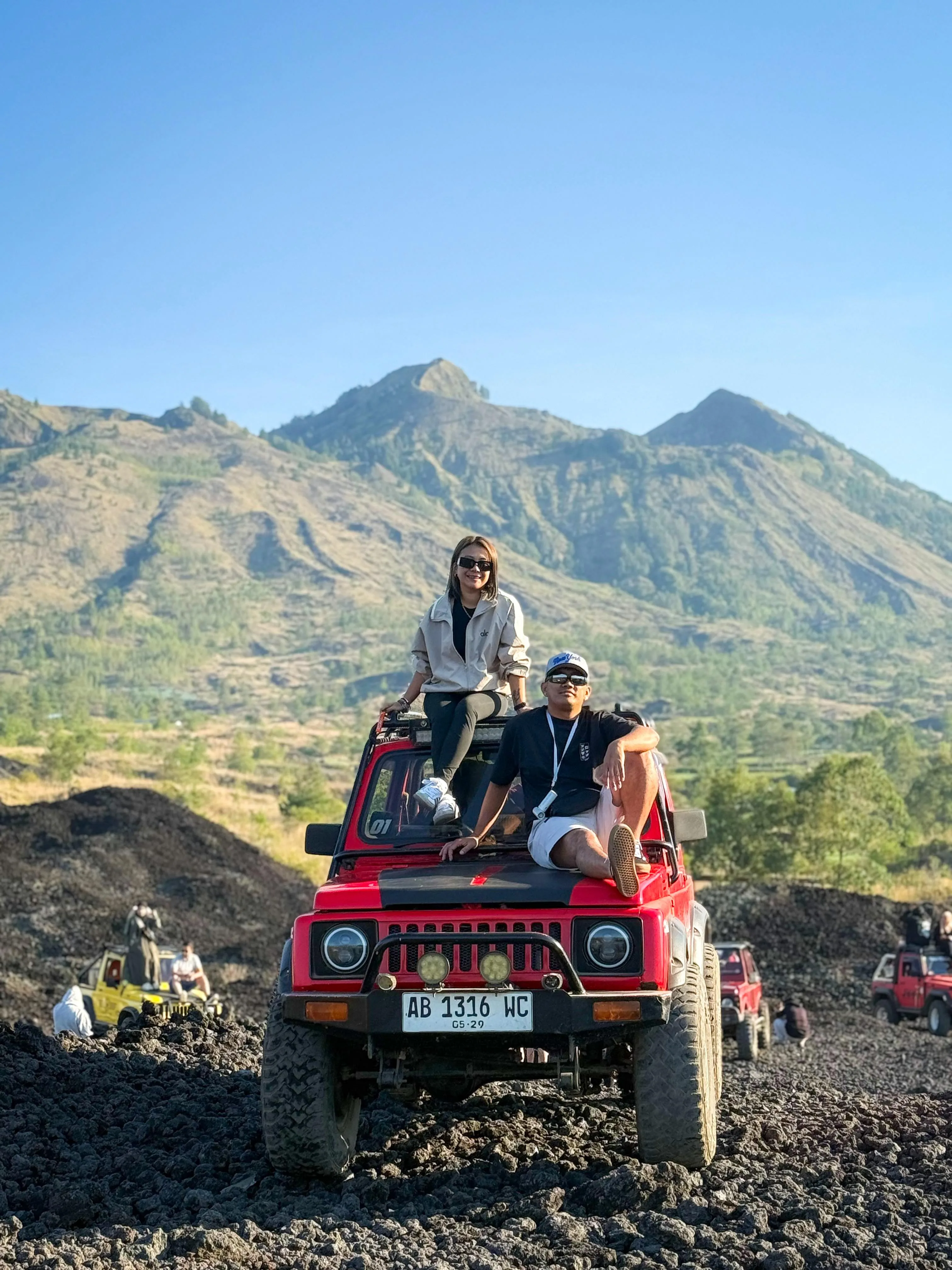Red jeep and travellers in the Black Lava landscape