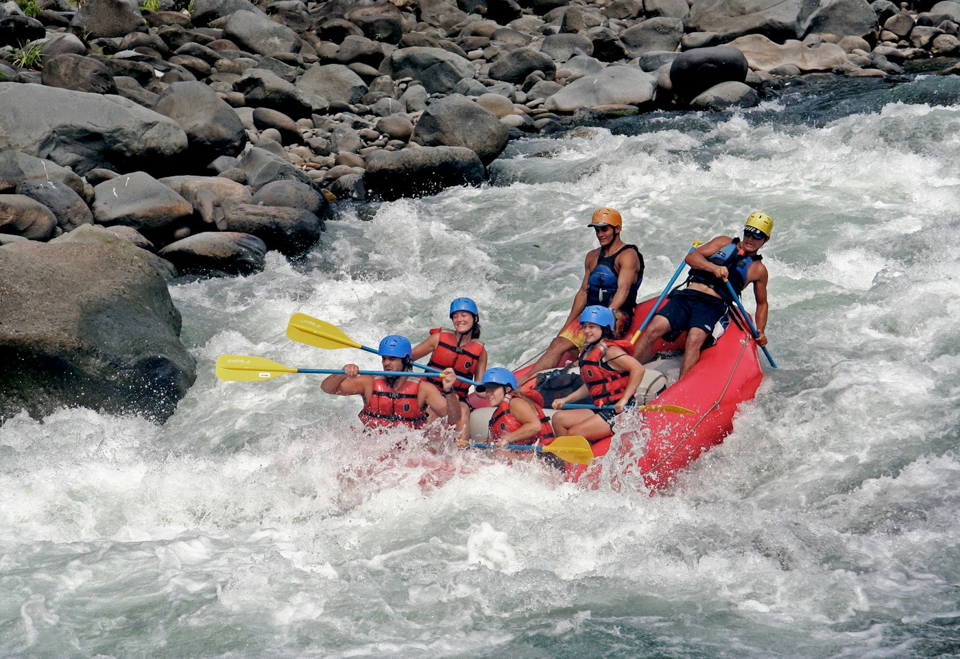 River rafting with paddlers wearing helmets and life jackets