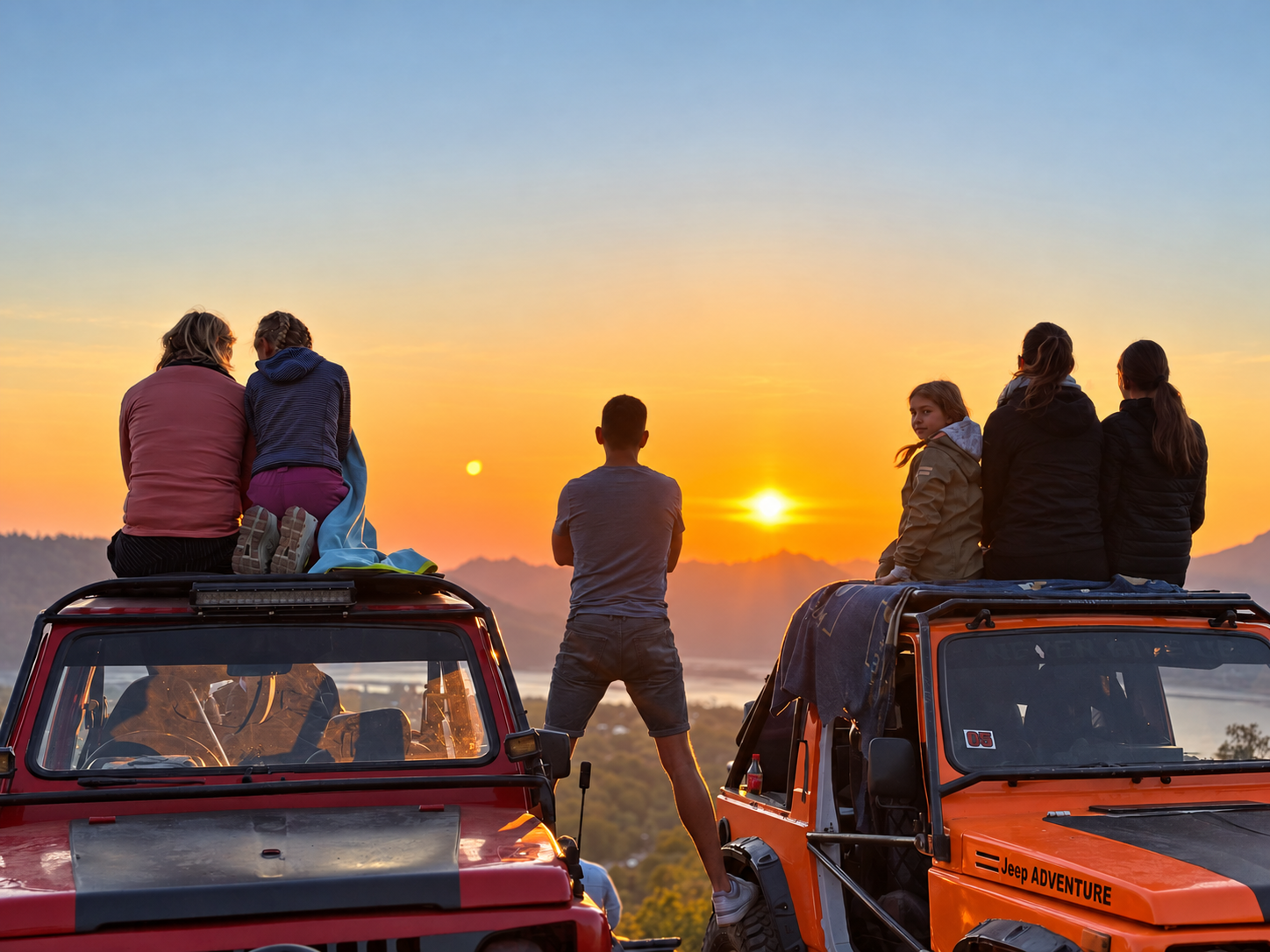 Guests watching the sunrise from two jeeps in Kintamani